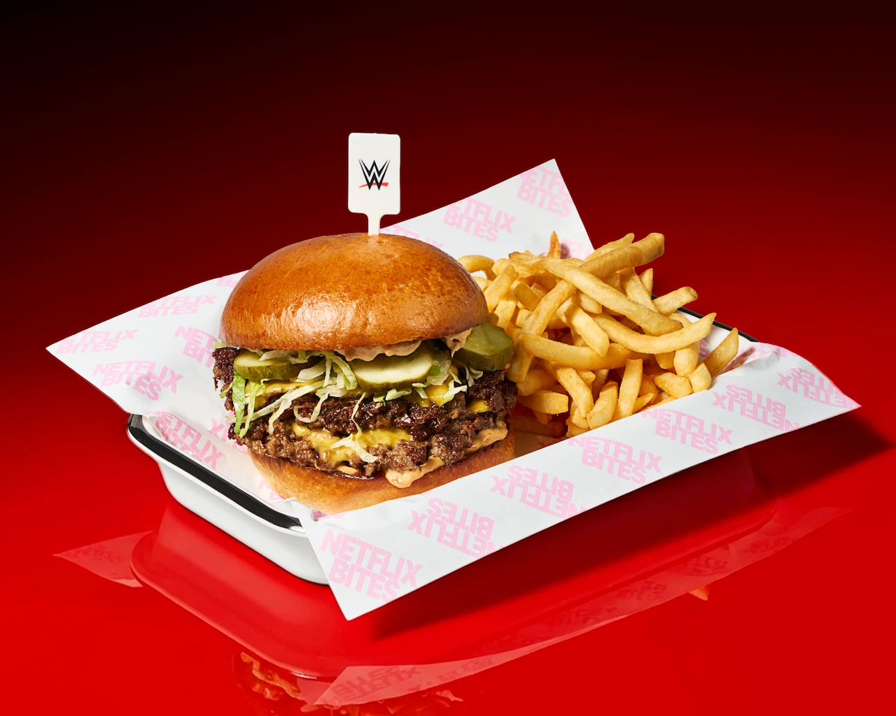 A plate of fries and a WWE themed smashburger. 