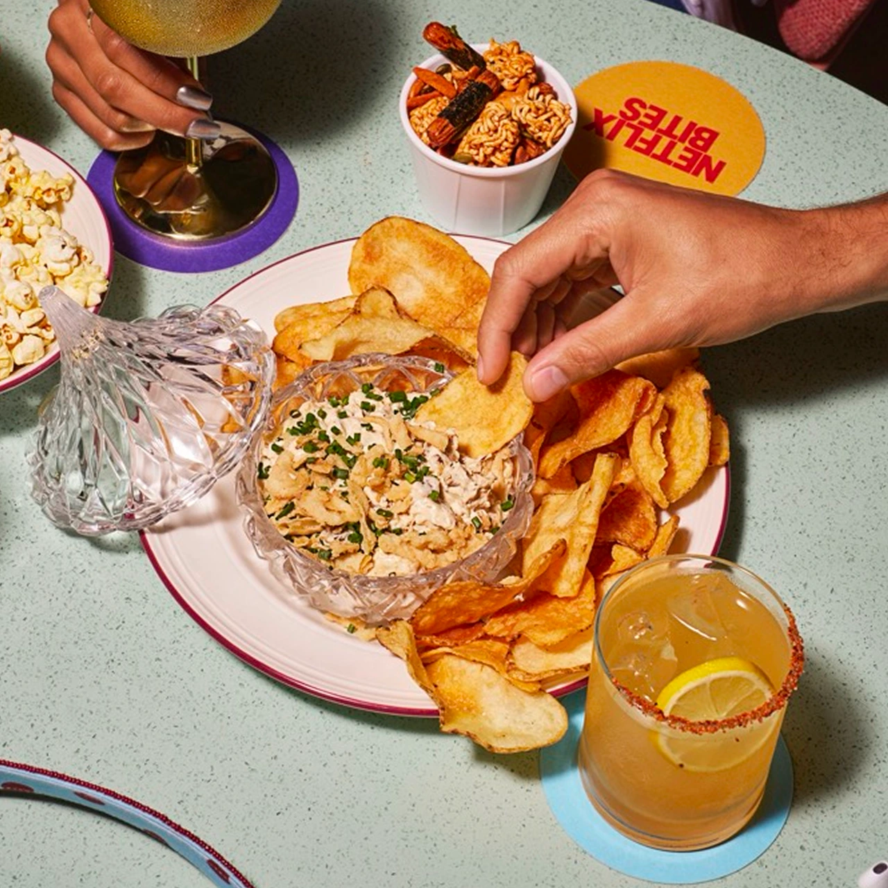 Friends enjoy caramelized onion dip and cocktails at Netflix Bites