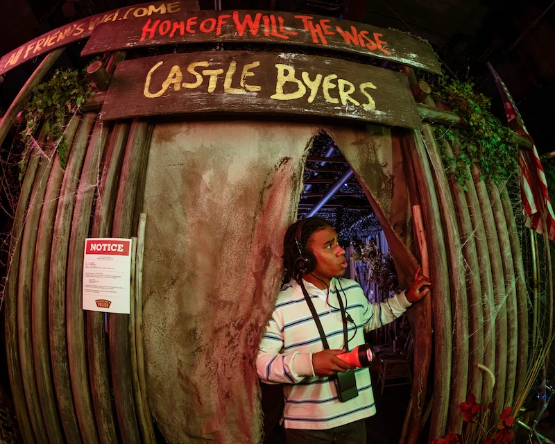 A child coming out of Castle Byers at the Stranger Things experience at Netflix House Dallas.