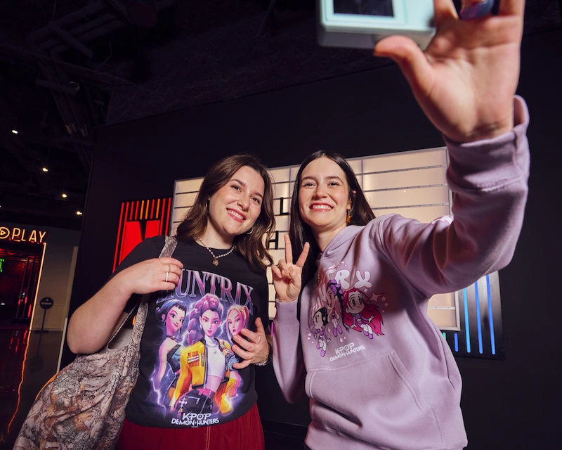 Fans in Netflix house wearing KPop Demon Hunters merch