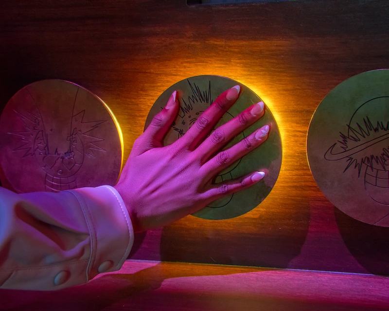 A hand presses a button to illuminate it on the wall
