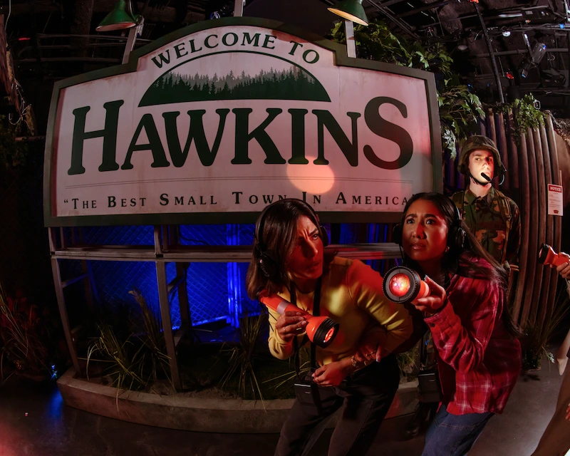 A group of friends exploring the Stranger Things experience at Netflix House Dallas.