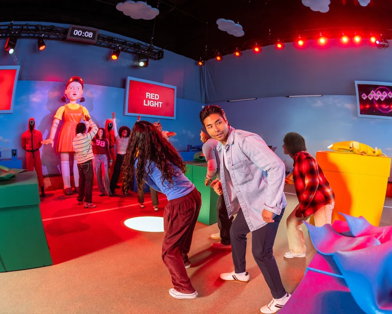 A group of friends plays Red Light, Green Light in the Squid Game immersive experience.