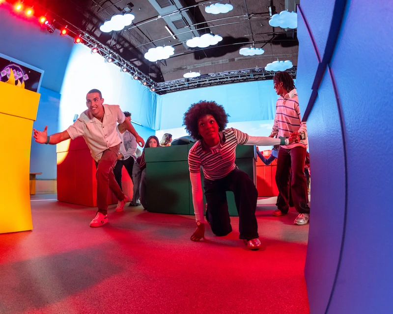 A group of friends play Red Light, Green Light game at the Squid Game immersive experience.