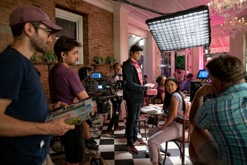 Noah Centineo as Peter Kavinsky and Lana Condor as Lara Jean filming in a cupcake shop.