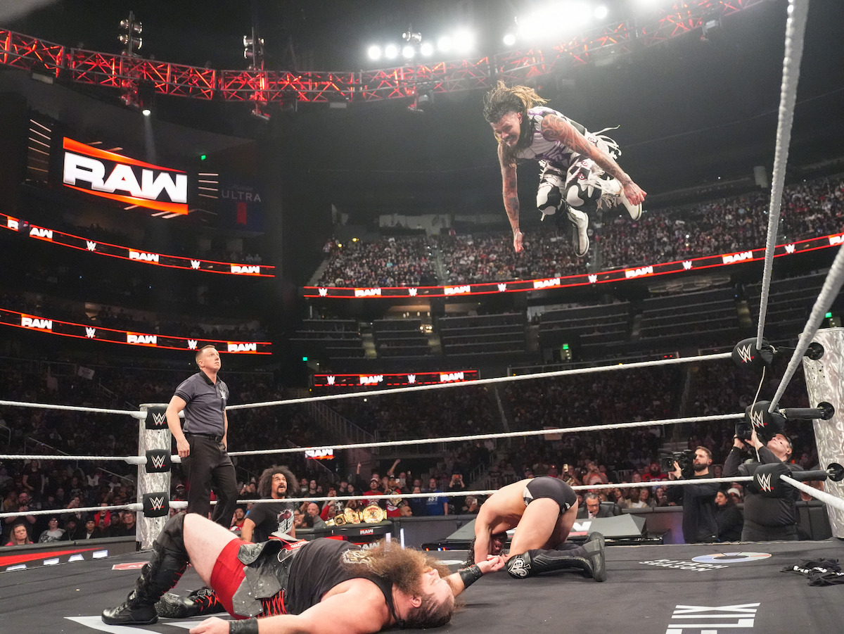 Dominik Mysterio dives into the ring against Erik