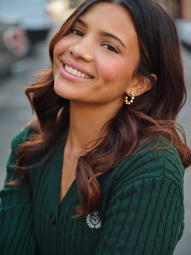 Nikki Rodriguez smiles wearing a green shirt for ‘My Life with the Walter Boys’