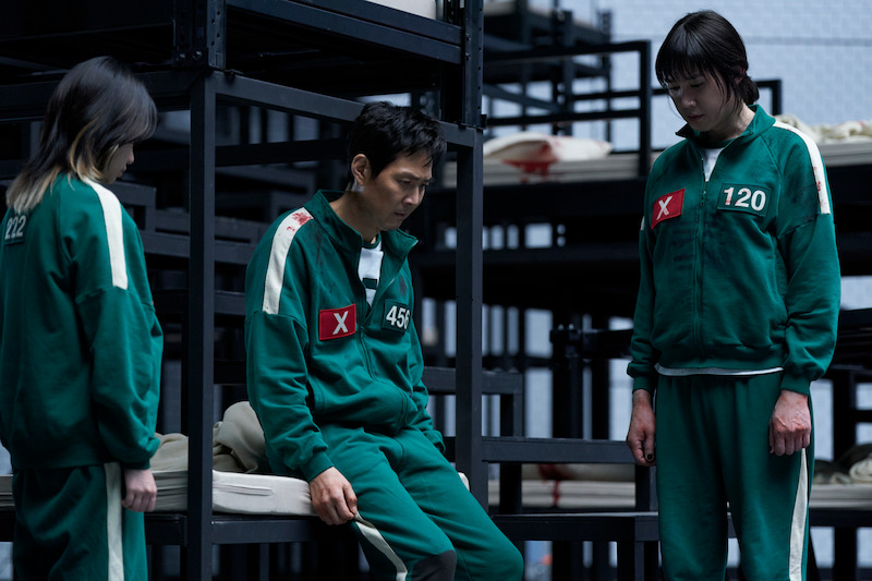 Jo Yu-ri as Jun-hee, Lee Jung-jae as Seong Gi-hun, Park Sung-hoon as Hyun-ju in 'Squid Game.'