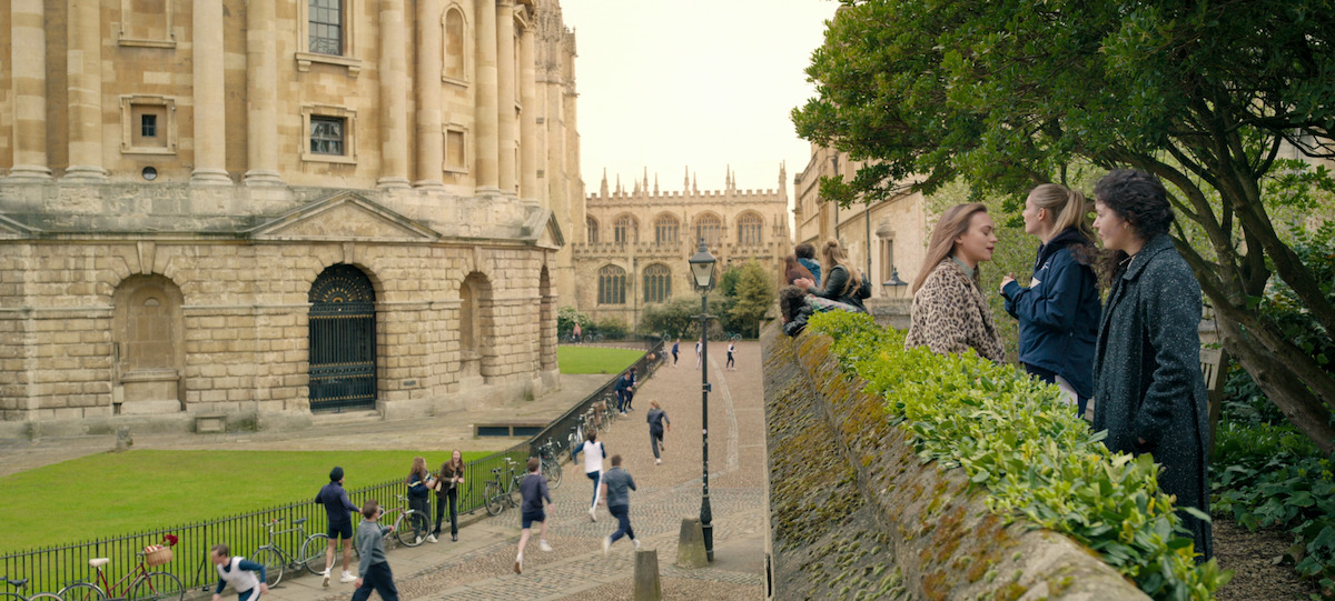 Sophie, in a flashback, watches the boys on the Oxford campus.