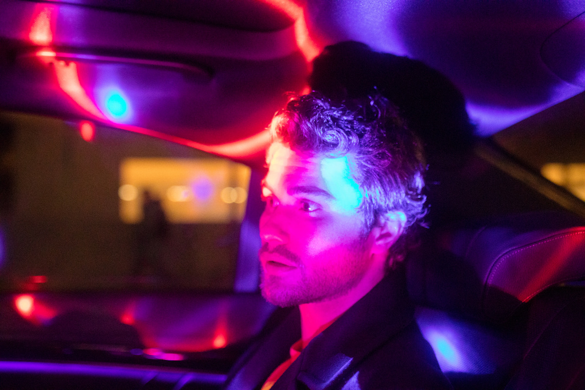 Chase Stokes in car.