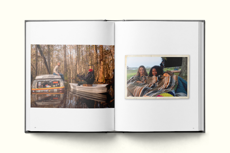Photo book open to two pages: left page shows people near a car and small boat in a wooded, flooded area; right page features two people smiling, wrapped in a blanket, outdoors, creating a cozy, relaxed atmosphere.