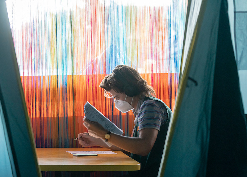 Reading lines or Steve’s (Joe Keery) date rolodex? - 68 Behind-the-Scenes pics from ‘Stranger Things’ Season 4 You Have to See Slideshow