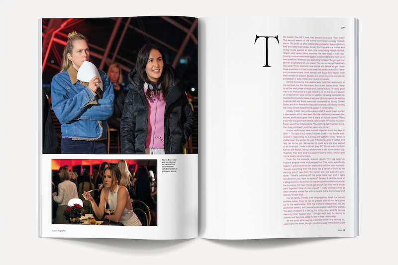 Magazine spread showing two women in jackets smiling indoors at night in the top photo, and a woman eating at a restaurant in the bottom photo; right page features a large block of magenta text with a decorative T.