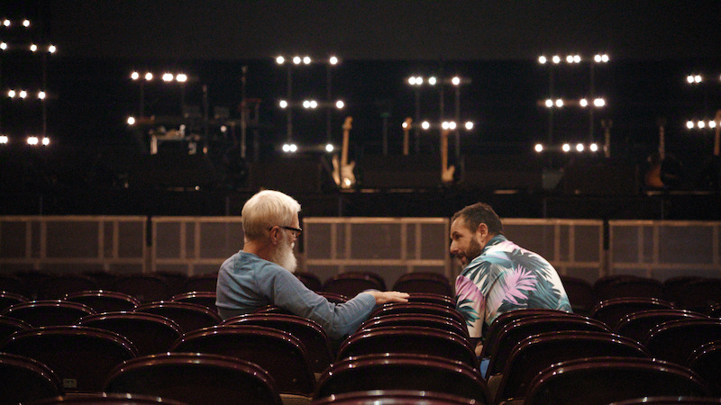 David Letterman and Adam Sandler sit in an empty theater.