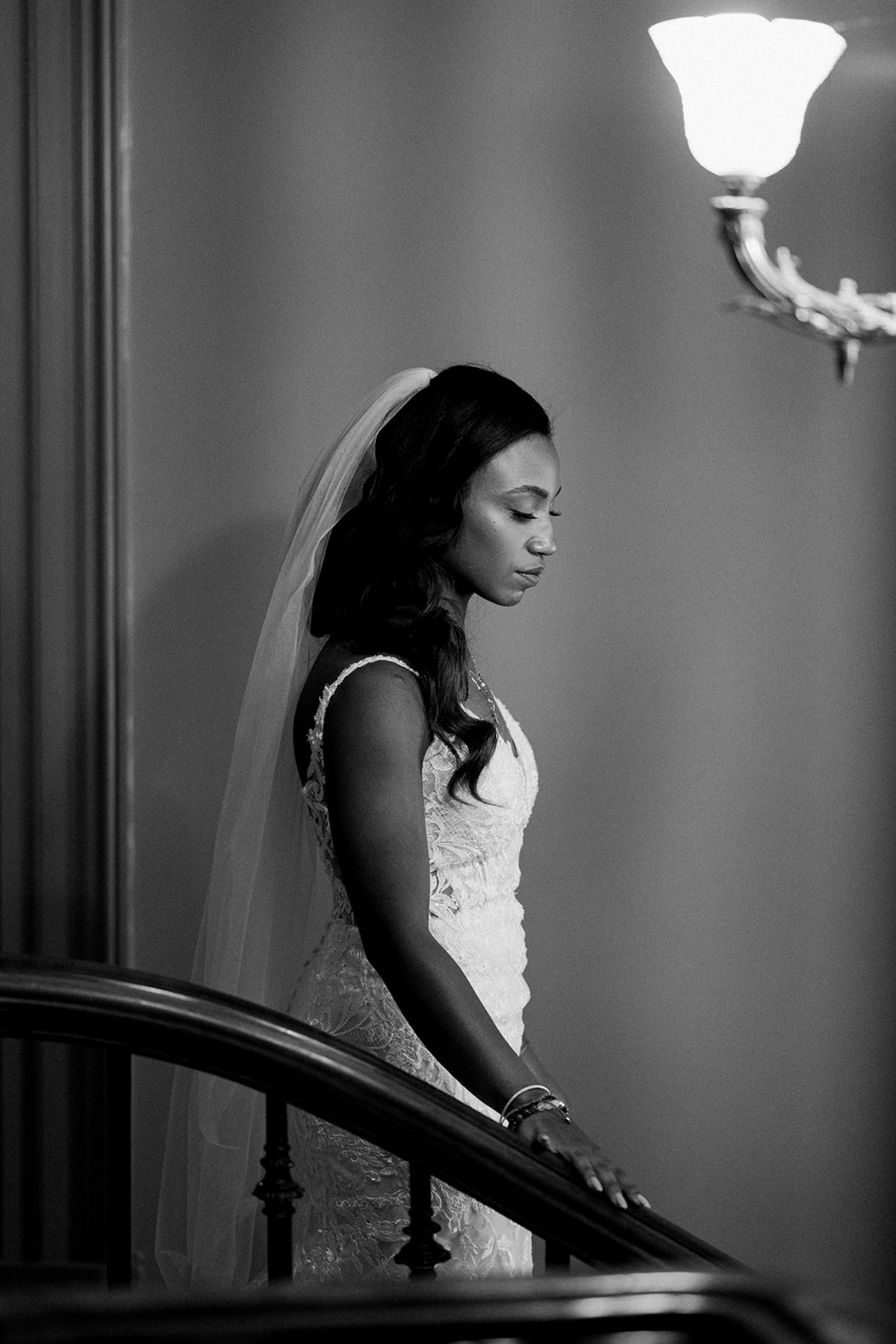 Nicole walking down the stairs in her wedding dress.