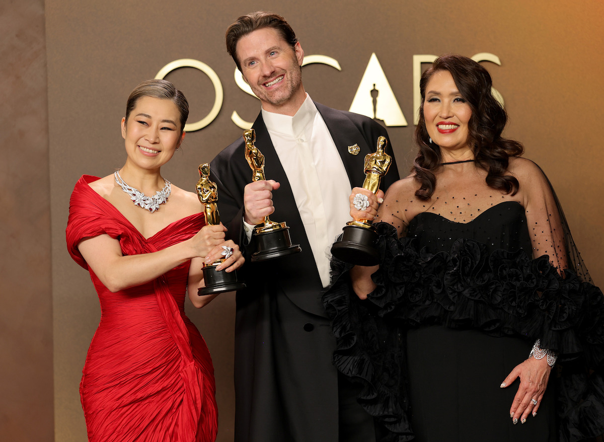 (L-R) Maggie Kang, Chris Appelhans, and Michelle L.M. Wong, winners of the Best Animated Feature Film Award for “KPop Demon Hunters”, pose in the press room during the 98th Oscars at Dolby Theatre on March 15, 2026 in Hollywood, California.