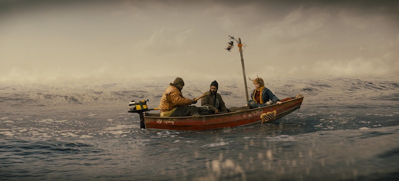 Nonso Anozie as Jepperd, Adeel Akhtar as Singh, Christian Convery as Gus ride in a small boat in a large icy ocean in Season 3 of 'Sweet Tooth'