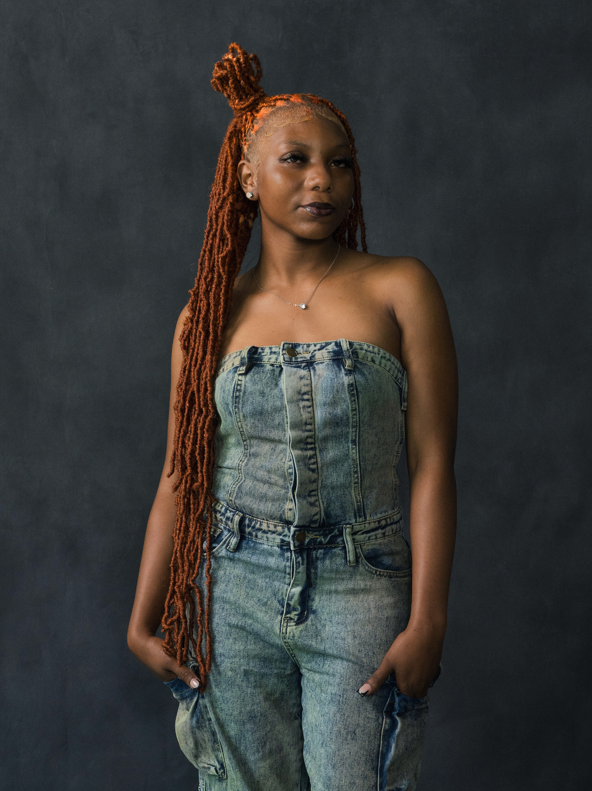 Ja'Ana Crudup wears a jean jumpsiot.