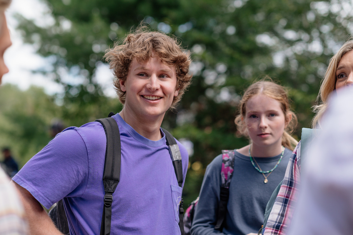 Colby Frost as Ben smiles as he stands next to Emerson MacNeil as Tracy in ‘Sullivan’s Crossing’ Season 4.