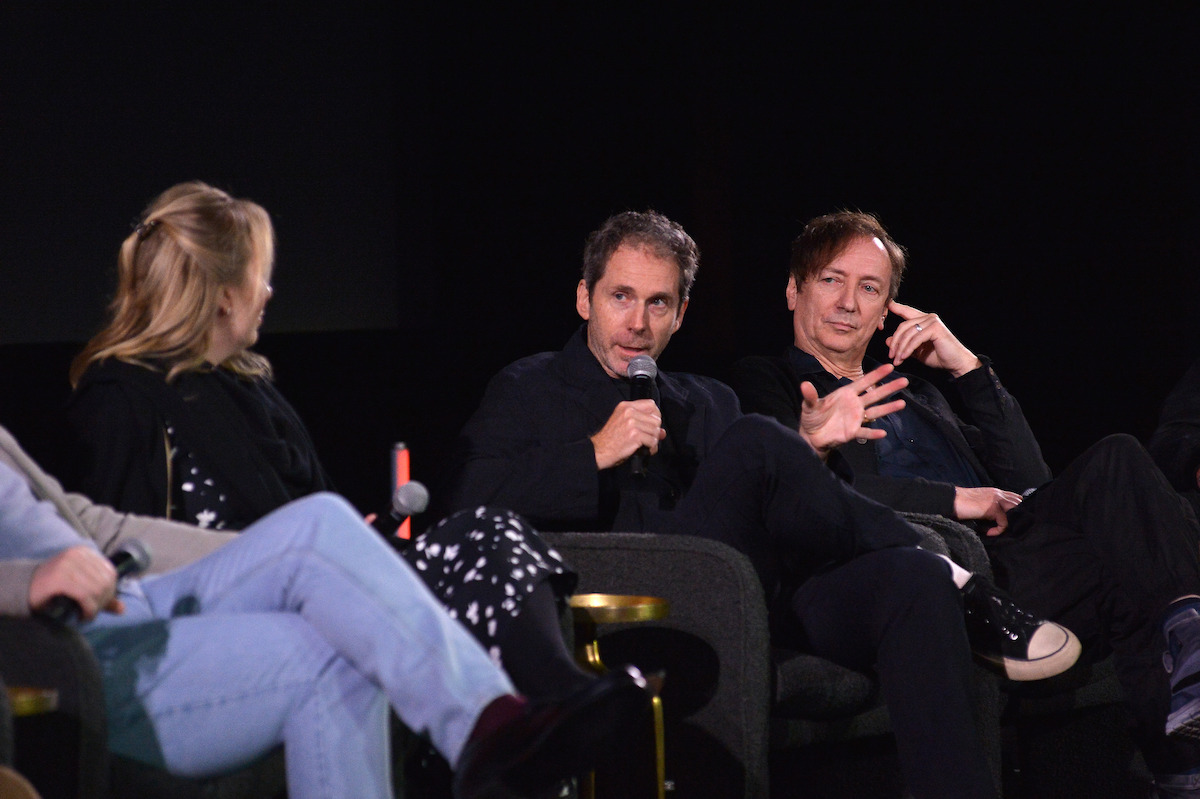 Kirk Baxter sits on stage with a microphone next to Volker Bertelmann.
