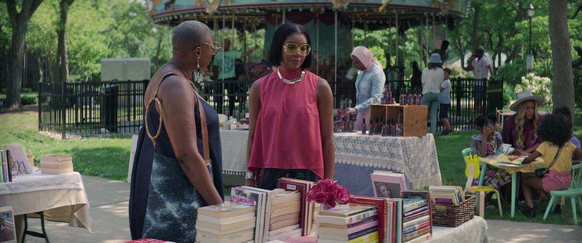 Gabrielle Union (right) wears a hot pink silk tank for a day at the farmers market with Aisha Hinds (left) in a still from ‘The Perfect Find.’
