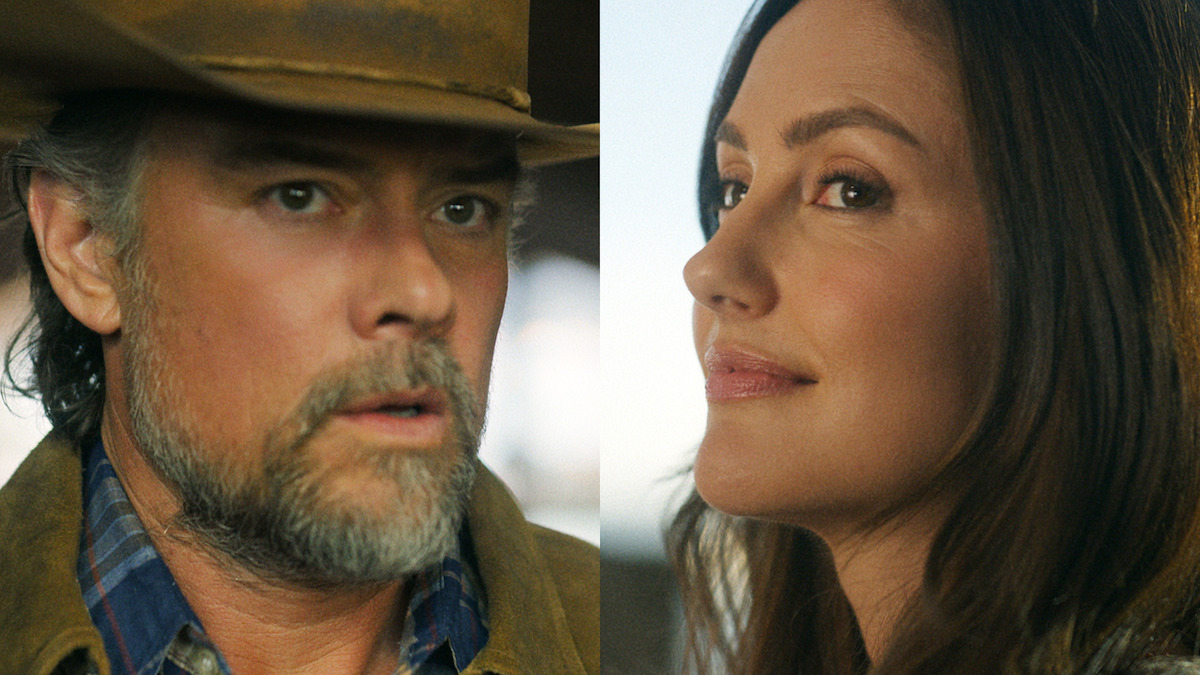 Close-up of a man in a cowboy hat and flannel shirt next to a woman with long brown hair, both outdoors in natural lighting, looking thoughtful.