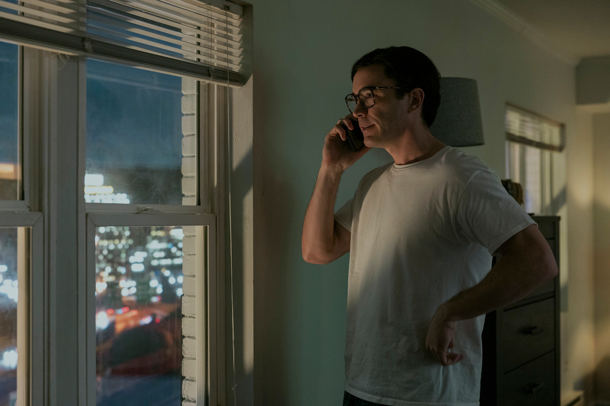 Tom Pelphrey as Raymond Peepgrass talks on the phone while looking out a window in ‘A Man In Full’