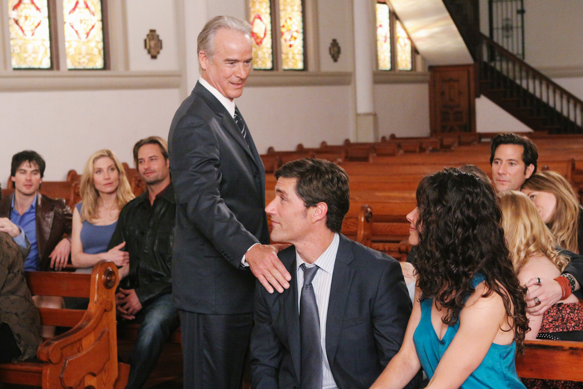 John Terry puts his arm on Matthew Fox while Ian Somerhalder, Elizabeth Mitchell, Josh Holloway, Evangeline Lilly, Emilie De Ravin (Obscured), Henry Ian Cusick, and Sonya Walger all sit together in a church.