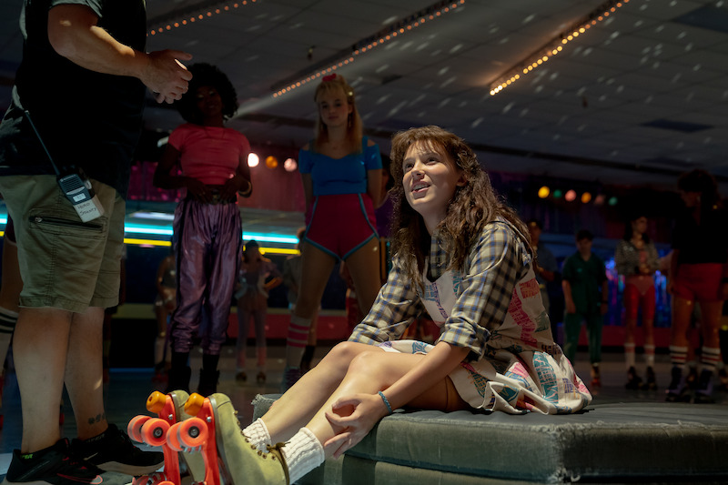Brown can always find her light — even in a roller rink. - 68 Behind-the-Scenes pics from ‘Stranger Things’ Season 4 You Have to See Slideshow