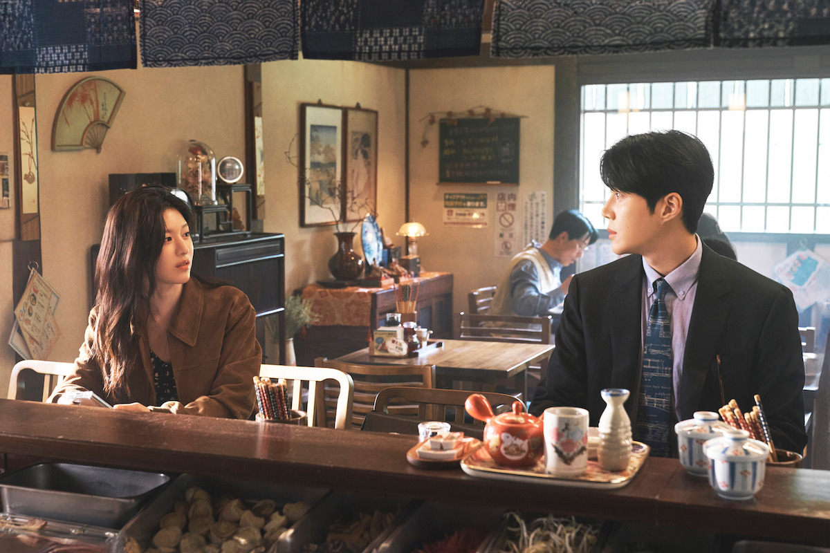 Cha Mu-hee and Joo Ho-jin sit in a restaurant in a scene from Can This Love Be Translated?