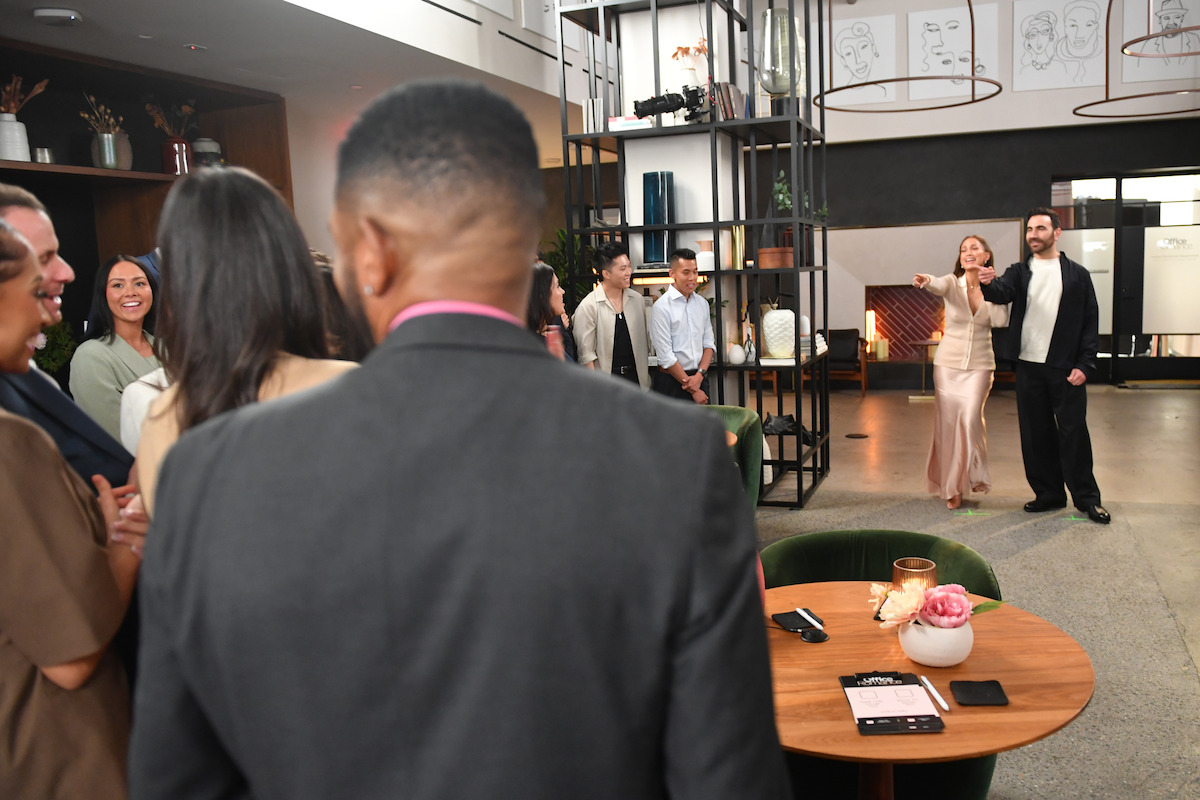 Jennifer Lopez and Brett Goldstein address a group of people attending a speed-dating event.