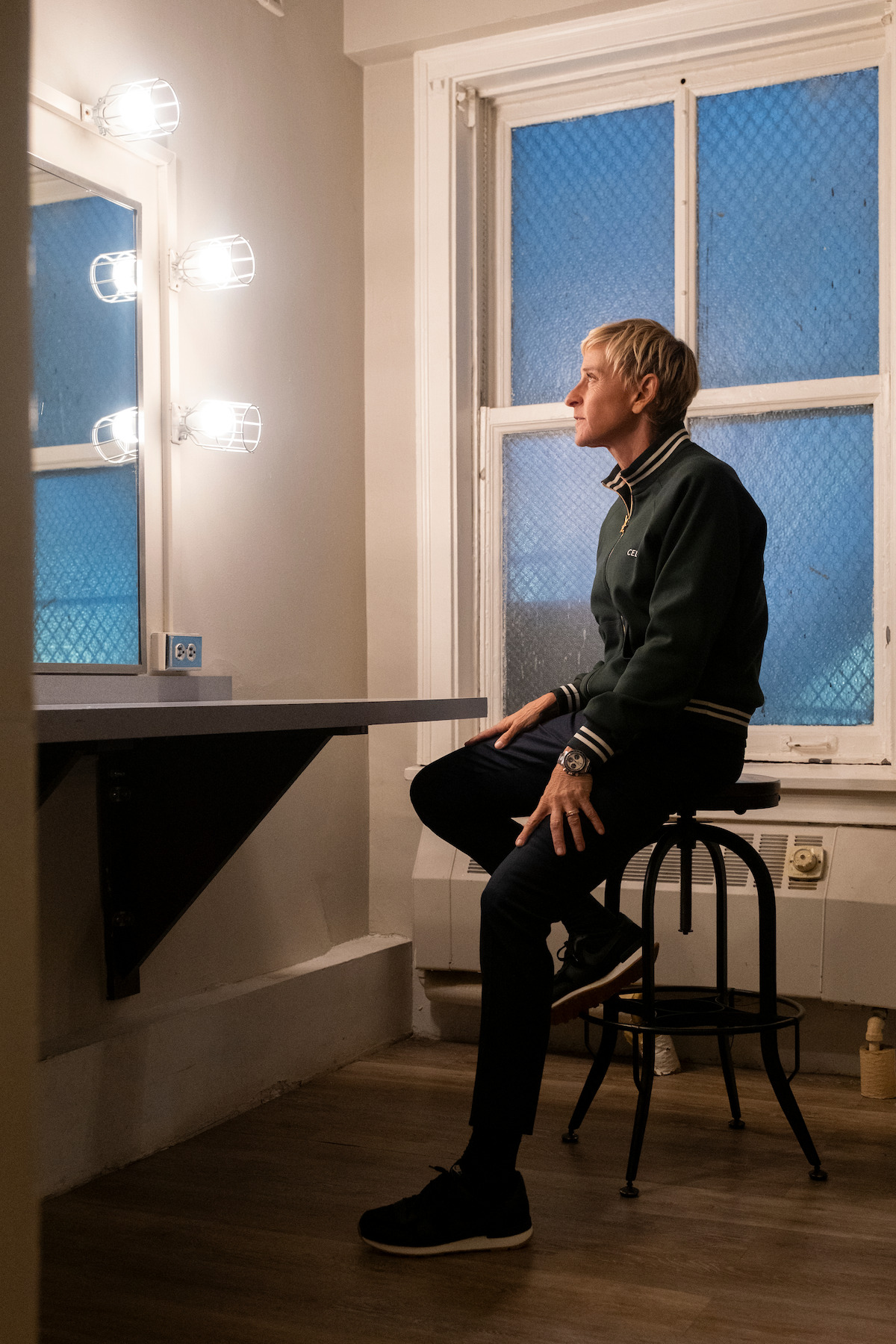 Ellen looks into a mirror while backstage before her show.