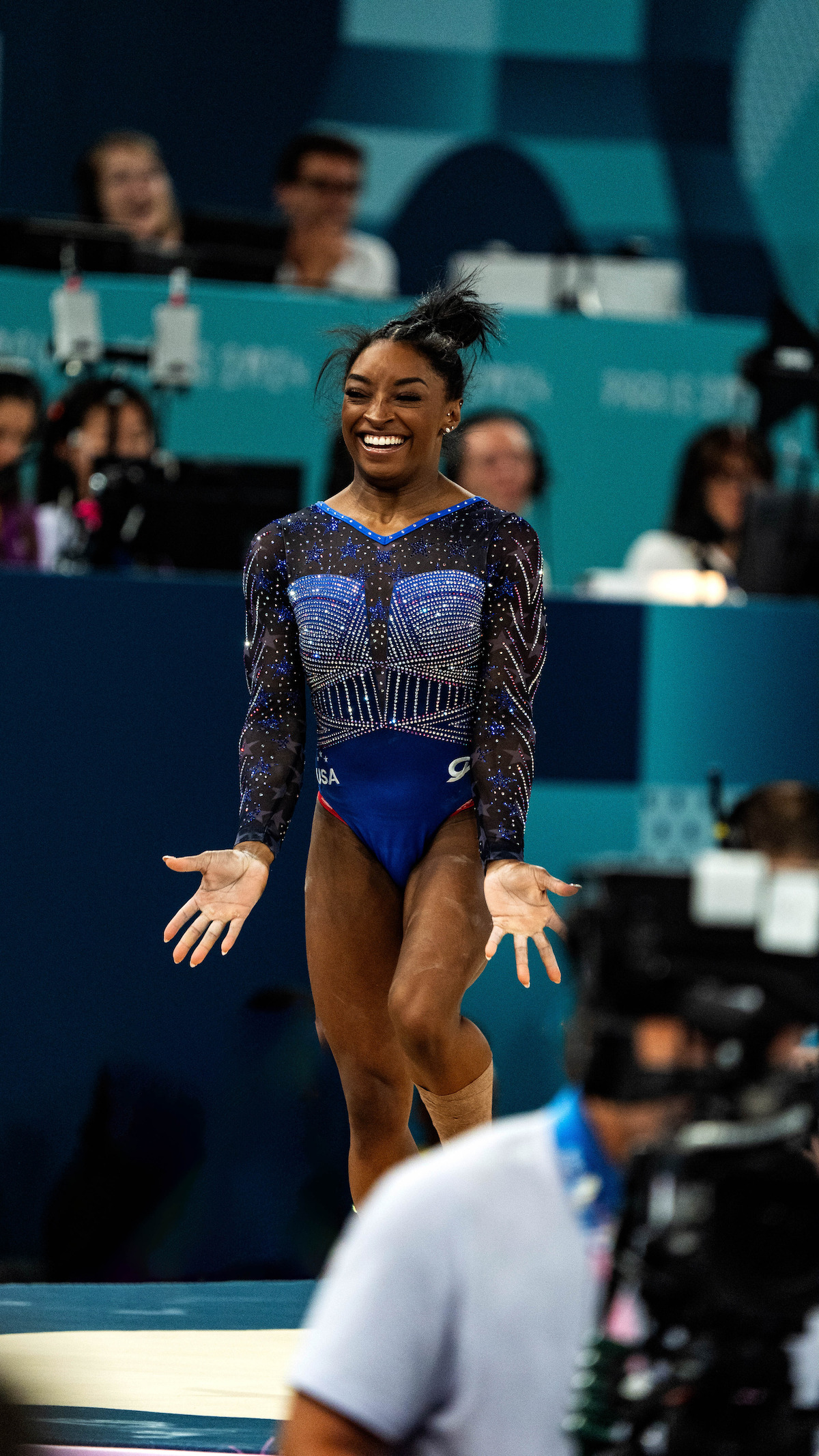 Simone Biles during smiling during a floor routine.