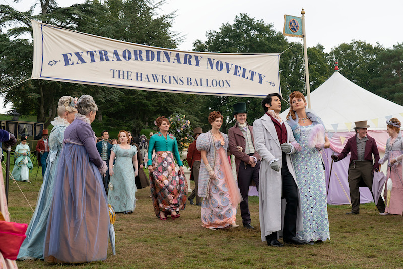The cast of season 3 of 'Bridgerton' strolls together outdoors. 