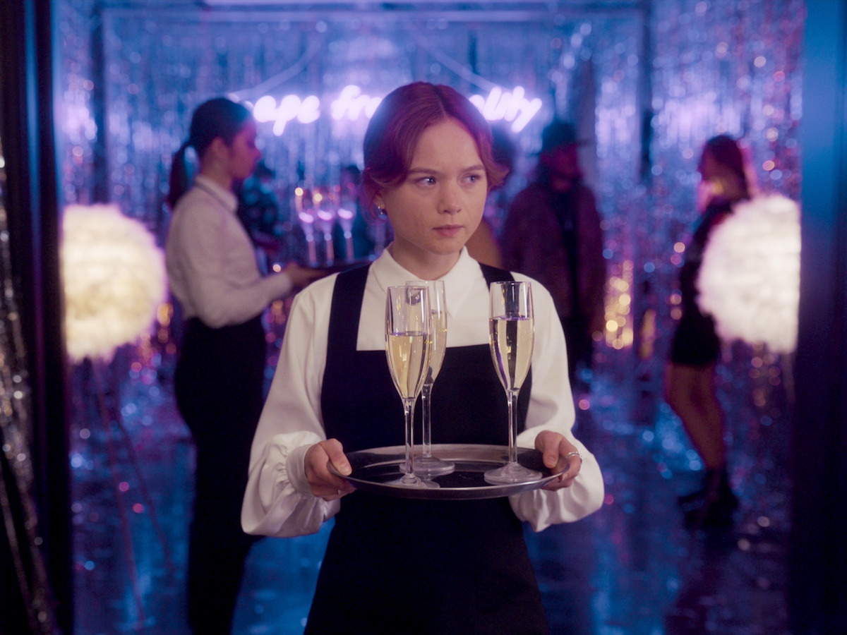 Lisi holding a drink tray at a party