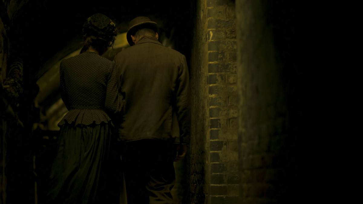 Two people walking down a dimly lit street in ‘Unsolved Mysteries,’ Volume 4, Episode 1, “Who Was Jack the Ripper?”