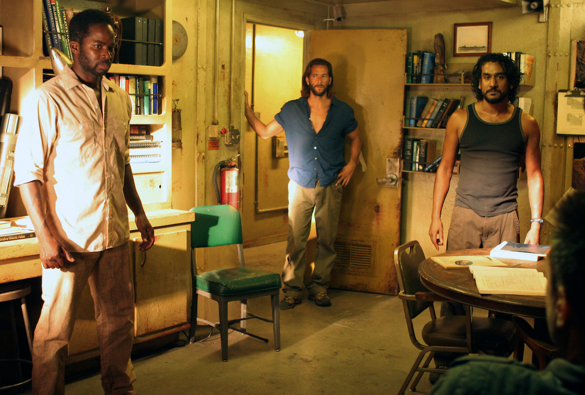 Harold Perrineau, Henry Ian Cusick, and Naveen Andrews standing in a room together.