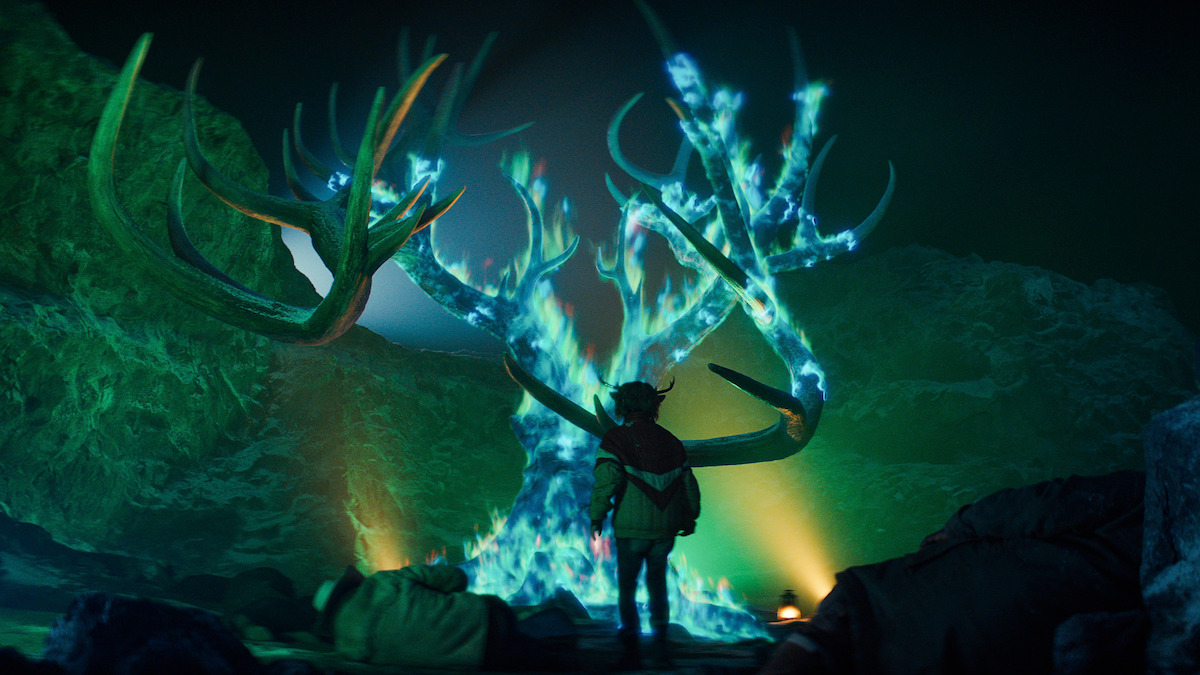 Christian Convery as Gus looks at a tree with antlers burning with blue fire in Season 3 of ‘Sweet Tooth.’
