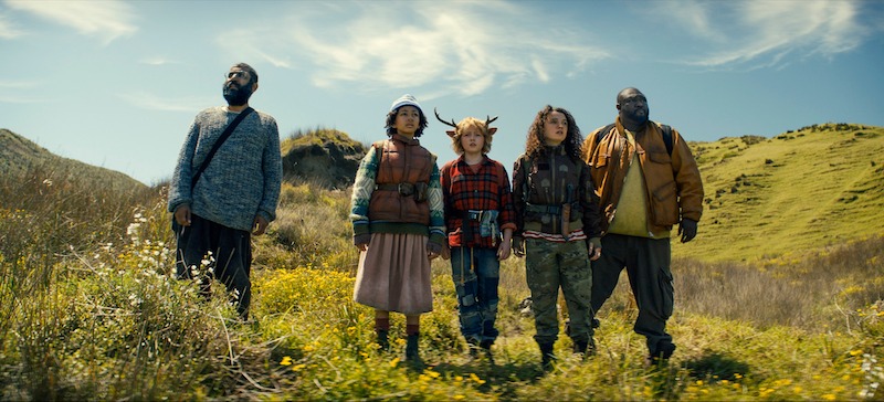 Adeel Akhtar as Singh, Naledi Murray as Wendy, Christian Convery as Gus, Stefania LaVie Owen as Becky, and Nonso Anozie as Jepperd stand on a mountainside in Season 3 of 'Sweet Tooth'
