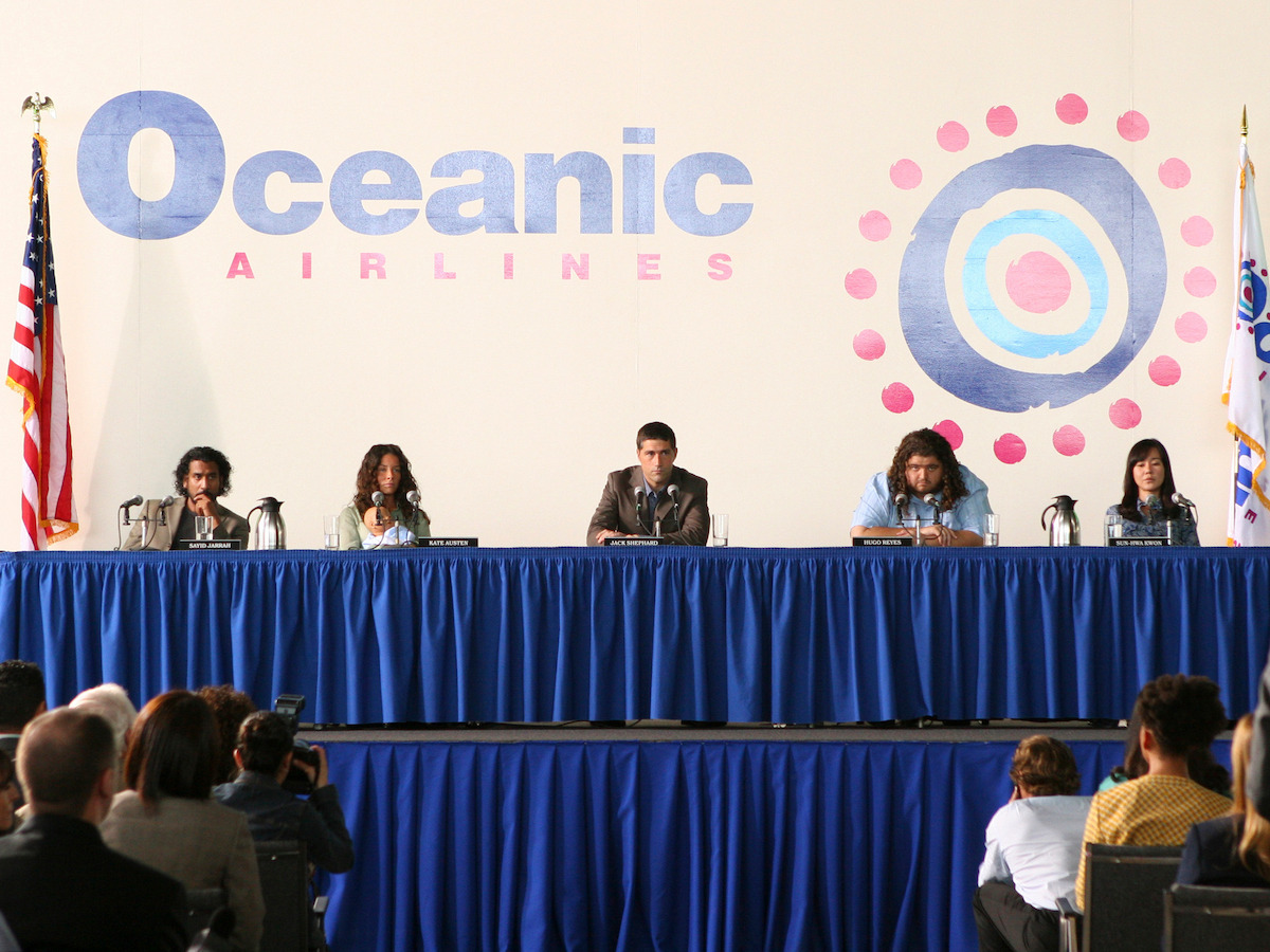 Naveen Andrews, Evangeline Lilly, Matthew Fox, Jorge Garcia and Yunjin Kim sit together at an Oceanic Airline press conference.