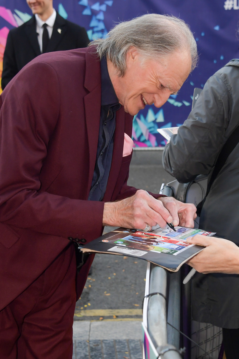 David Bradley signs autographs on the Pinocchio red carpet. - ‘Guillermo del Toro’s Pinocchio’ Cast at the London Film Festival