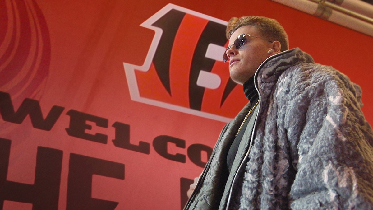 Joe Burrow walking into the stadium wearing sunglasses and a coat.