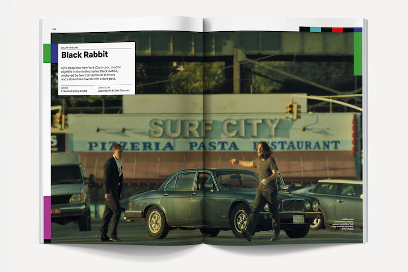 Two men stand by a vintage car on a city street in front of the Surf City Pizzeria Pasta Restaurant sign, with traffic lights and other vehicles, creating an urban, possibly tense atmosphere.