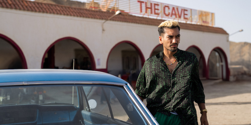 Nabhaan Rizwan as Dionysus walks out of a market in 'KAOS'