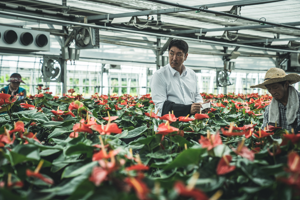 Cho Jin-woong as Cho Won-ho stands amidst flowers in ‘Believer 2.’