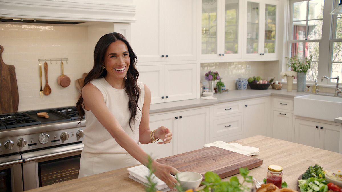 Meghan laughing in the kitchen.