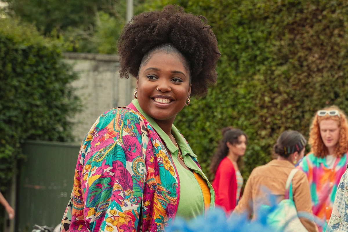 Alexandra James as Aisha smiles in Season 4 of ‘Sex Education.’