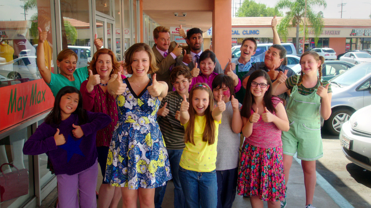 a group of people giving a thumbs up to the camera. 