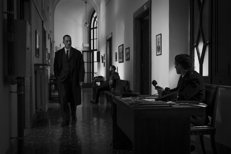 Maurizio Lombardi as Inspector Ravin walks through a hallway in 'Ripley'