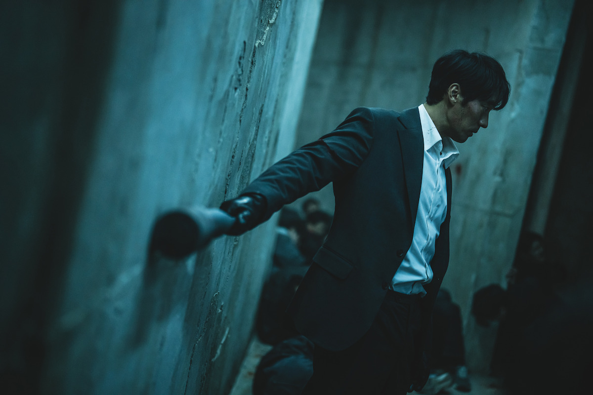 So Ji-Sub as Nam Gi-jun drags a bat along a cement wall in an image from ‘Mercy for None.’